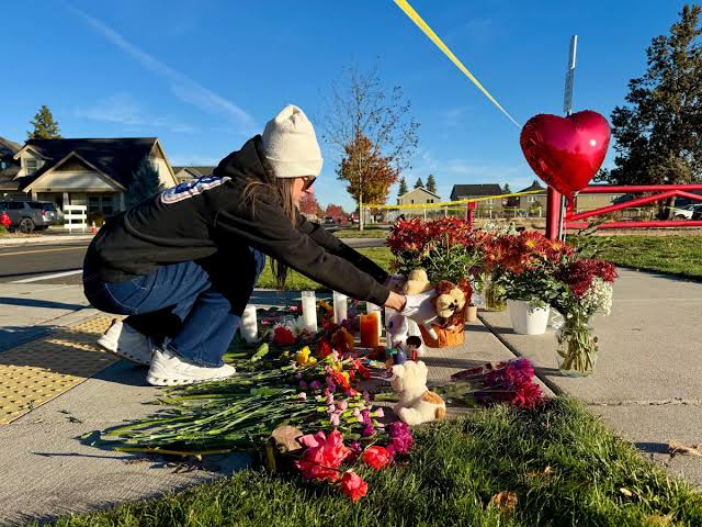 Community members mourn at a makeshift memorial